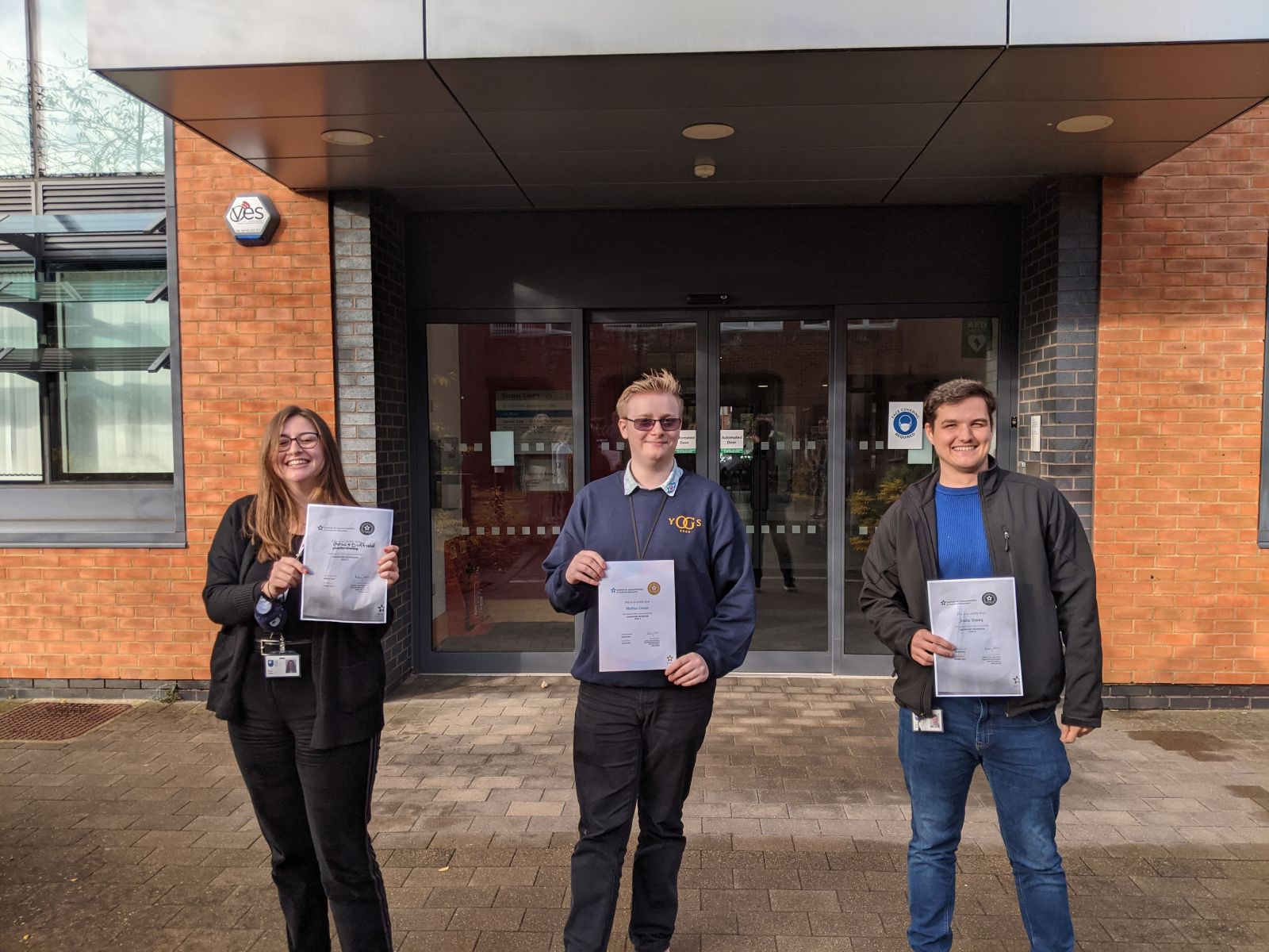 Three STEM OU apprentices proudly holding their certificates.