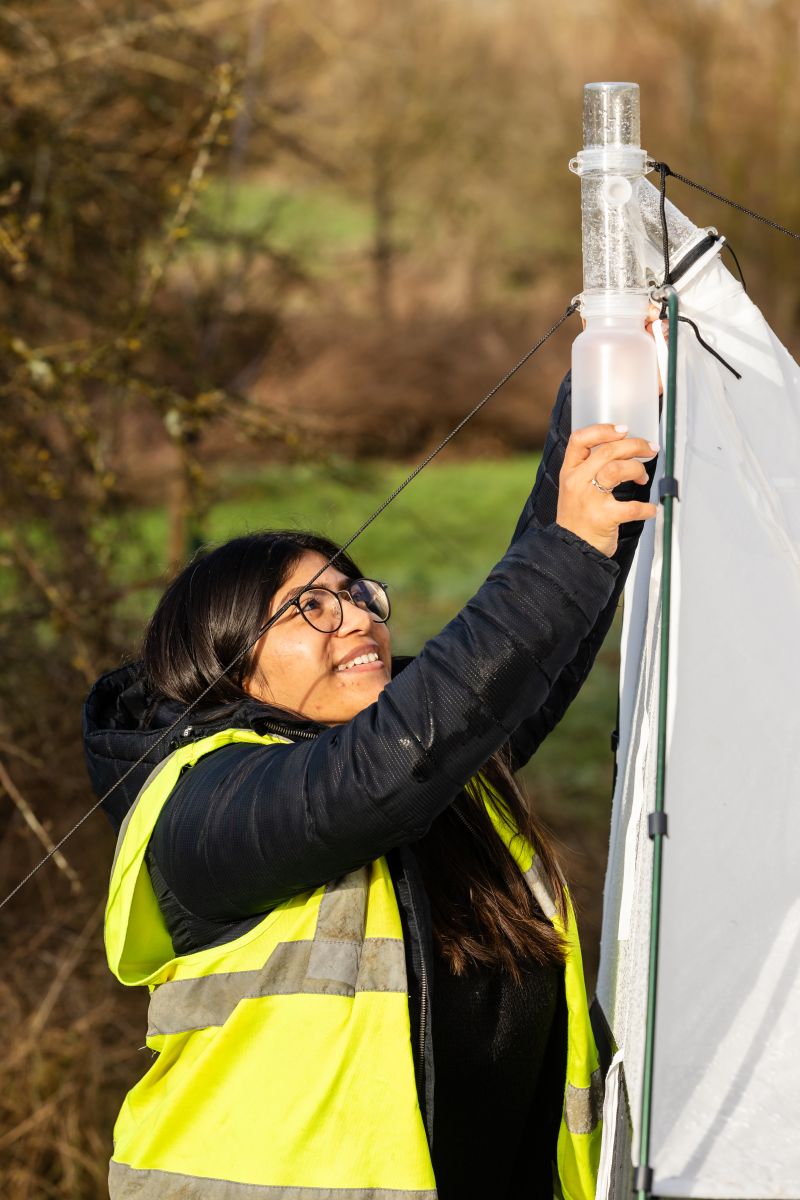 Person wear a hi-viz jacket doing fieldwork experiments 