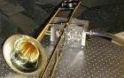 Trombone linked to test equipment in acoustics laboratory