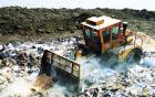 Bulldozer clearing rubbish at waste faciltity